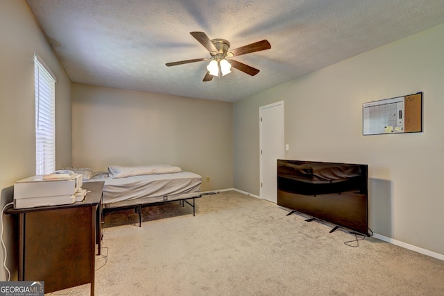 5026 Brittany Dr, Stone Mountain, GA 30083 - carpeted bedroom featuring a textured ceiling and ceiling fan