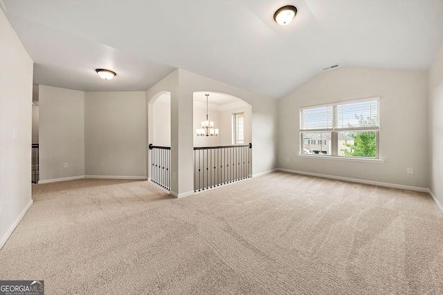 3865 Rifflepool Ct, Douglasville, GA 30135 - carpeted empty room with vaulted ceiling, arched walkways, and a chandelier