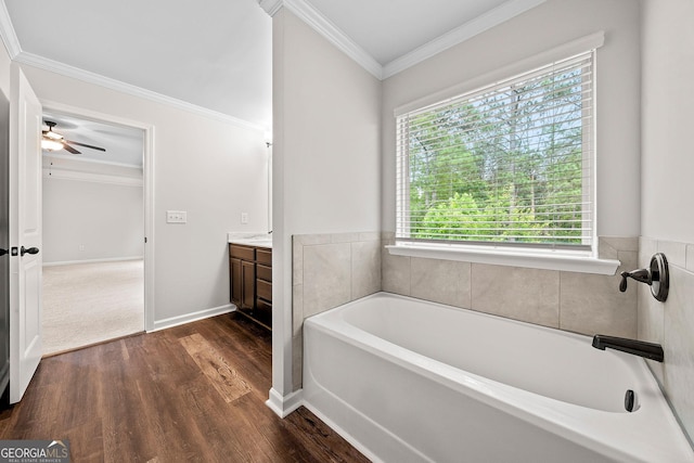 3865 Rifflepool Ct, Douglasville, GA 30135 - full bath with vanity, plenty of natural light, a garden tub, ornamental molding, and wood finished floors
