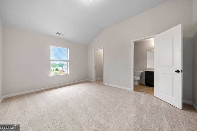 3865 Rifflepool Ct, Douglasville, GA 30135 - unfurnished bedroom with vaulted ceiling, light colored carpet, and ensuite bath