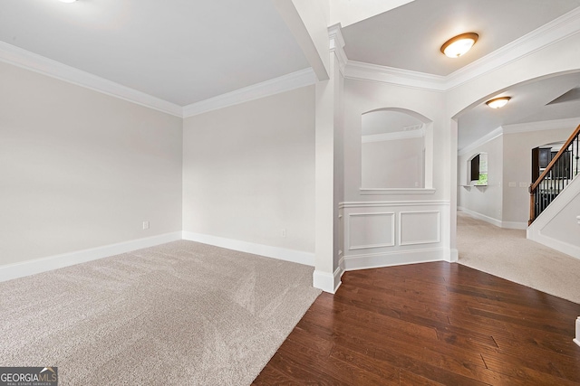 3865 Rifflepool Ct, Douglasville, GA 30135 - carpeted empty room with crown molding, wood finished floors, arched walkways, and stairway