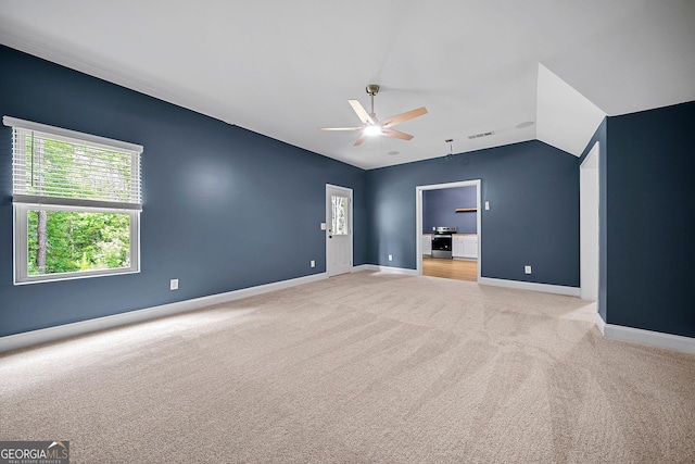 3865 Rifflepool Ct, Douglasville, GA 30135 - spare room with a ceiling fan, light colored carpet, vaulted ceiling, and plenty of natural light