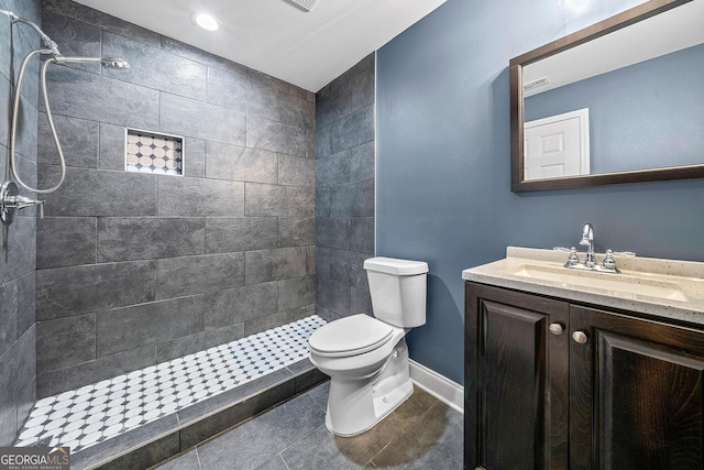 3865 Rifflepool Ct, Douglasville, GA 30135 - bathroom featuring vanity, tiled shower, and tile patterned floors