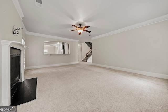 3865 Rifflepool Ct, Douglasville, GA 30135 - unfurnished living room featuring ornamental molding, a ceiling fan, carpet flooring, a fireplace, and stairs