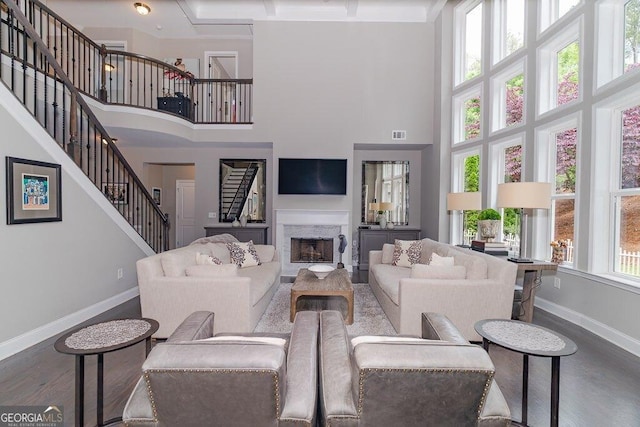 2720 Garonne Way, Cumming, GA 30041 - living room with a towering ceiling, wood finished floors, stairs, and a premium fireplace