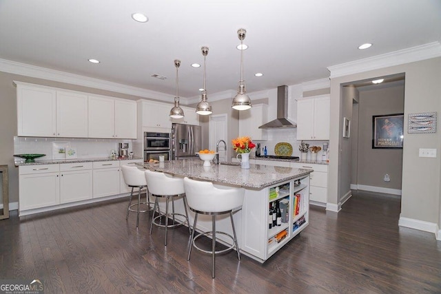 2720 Garonne Way, Cumming, GA 30041 - kitchen with wall chimney range hood, appliances with stainless steel finishes, tasteful backsplash, white cabinetry, and recessed lighting