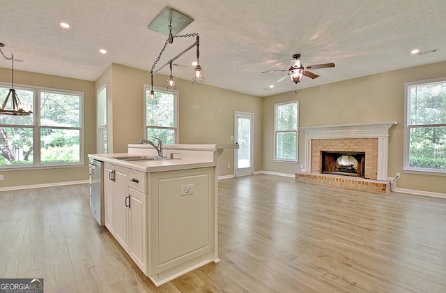 1709 Reese Rd, Sharpsburg, GA 30277 - kitchen with light wood finished floors, recessed lighting, a textured ceiling, an island with sink, and a ceiling fan