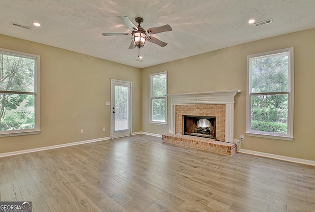 1709 Reese Rd, Sharpsburg, GA 30277 - unfurnished living room featuring ceiling fan, a textured ceiling, plenty of natural light, wood finished floors, and recessed lighting