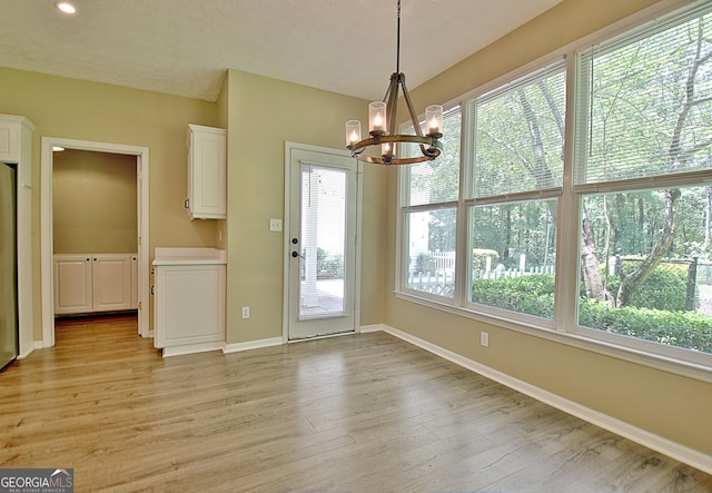 1709 Reese Rd, Sharpsburg, GA 30277 - unfurnished dining area with a chandelier, light wood-style floors, and recessed lighting