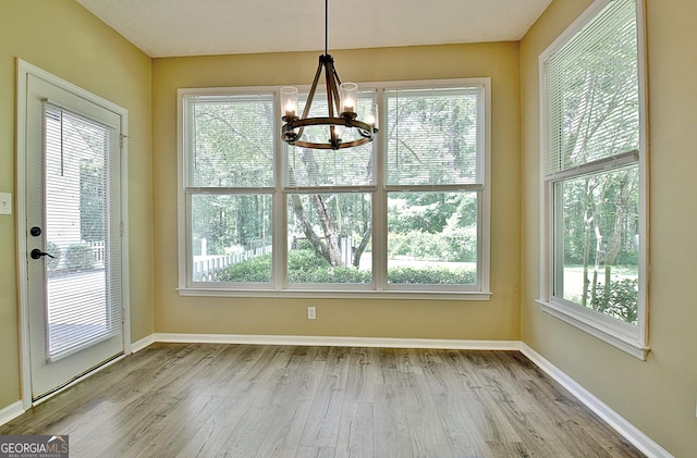 1709 Reese Rd, Sharpsburg, GA 30277 - unfurnished dining area featuring a chandelier, healthy amount of natural light, and wood finished floors