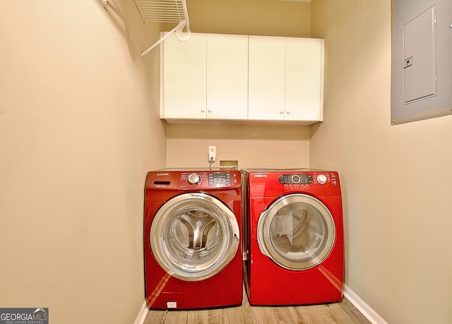 1709 Reese Rd, Sharpsburg, GA 30277 - laundry room with electric panel, cabinet space, washer and dryer, and wood finished floors