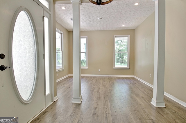 1709 Reese Rd, Sharpsburg, GA 30277 - foyer entrance featuring decorative columns, light wood-type flooring, and recessed lighting