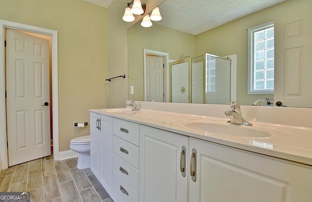 1709 Reese Rd, Sharpsburg, GA 30277 - full bathroom featuring double vanity, a shower stall, a chandelier, and a textured ceiling