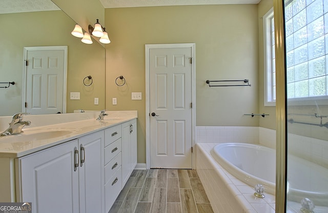 1709 Reese Rd, Sharpsburg, GA 30277 - bathroom with double vanity, a bath, and a chandelier