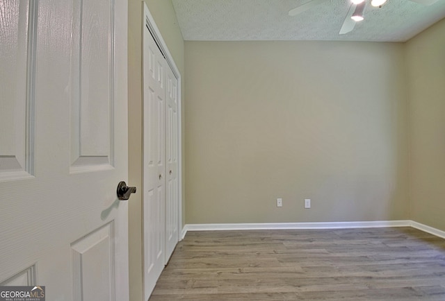 1709 Reese Rd, Sharpsburg, GA 30277 - unfurnished bedroom with a textured ceiling, light wood finished floors, a closet, and a ceiling fan