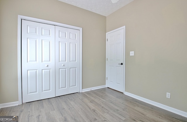 1709 Reese Rd, Sharpsburg, GA 30277 - unfurnished bedroom with wood finished floors, a closet, and a textured ceiling