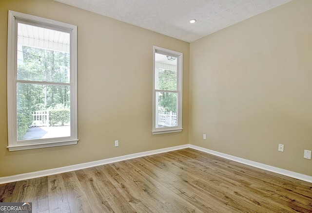 1709 Reese Rd, Sharpsburg, GA 30277 - spare room with wood finished floors, a textured ceiling, and recessed lighting