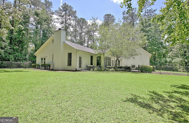 1709 Reese Rd, Sharpsburg, GA 30277 - back of property with a chimney and view of scattered trees
