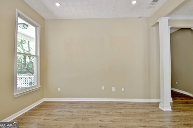 1709 Reese Rd, Sharpsburg, GA 30277 - spare room with light wood-type flooring, recessed lighting, and ornate columns