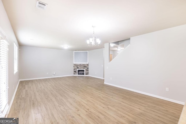 243 Flowing Meadows Dr, Kathleen, GA 31047 - unfurnished living room featuring a chandelier and light wood-style flooring