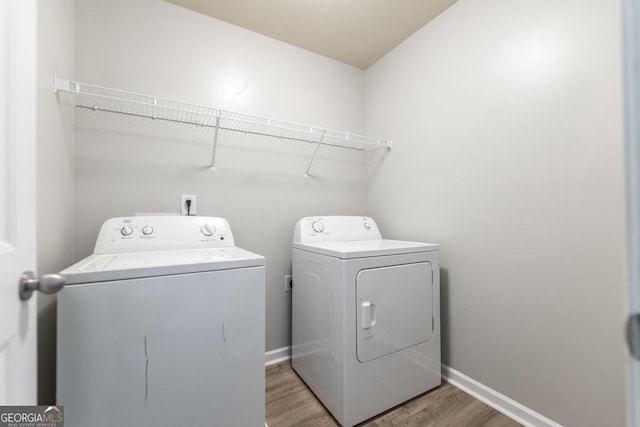 243 Flowing Meadows Dr, Kathleen, GA 31047 - laundry room with washing machine and dryer and light wood-style floors