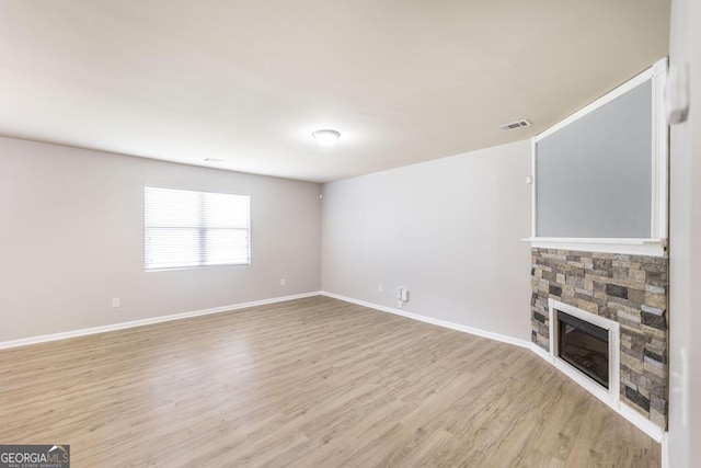 243 Flowing Meadows Dr, Kathleen, GA 31047 - unfurnished living room featuring light wood-style flooring and a fireplace