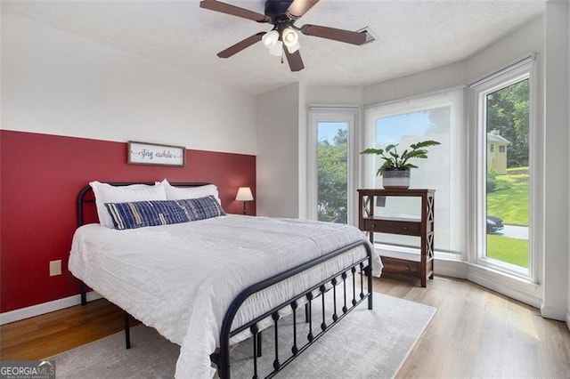 1452 Crooked Tree Cir, Stone Mountain, GA 30088 - bedroom featuring light wood finished floors and ceiling fan