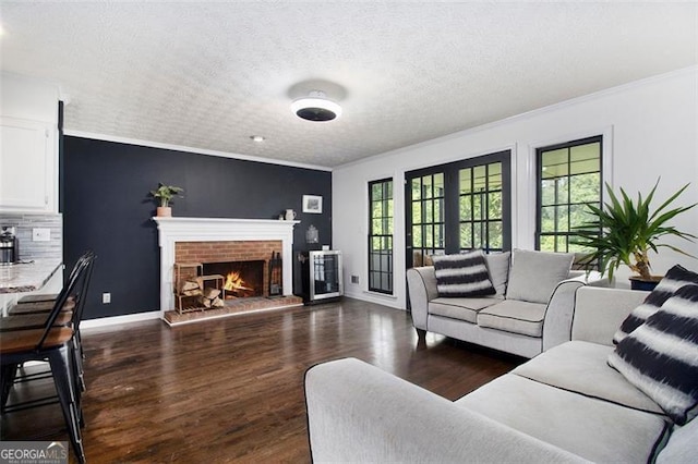 1452 Crooked Tree Cir, Stone Mountain, GA 30088 - living room featuring ornamental molding, a brick fireplace, a textured ceiling, and wood finished floors