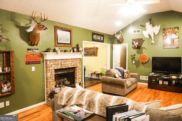 1665 Jackson Lake Rd, Mansfield, GA 30055 - living room with ceiling fan, wood finished floors, vaulted ceiling, and a stone fireplace