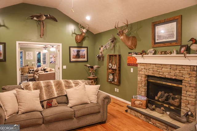 1665 Jackson Lake Rd, Mansfield, GA 30055 - living area with wood finished floors, lofted ceiling, ceiling fan, and a fireplace