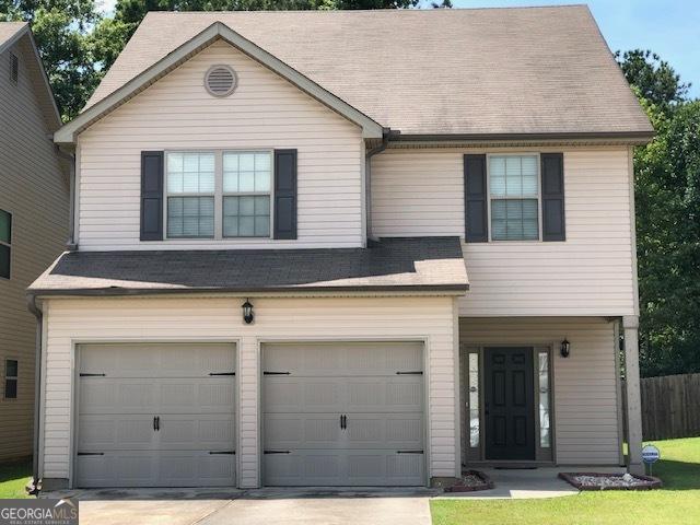 7609 Garnet Dr, Jonesboro, GA 30236 - view of front of home featuring a garage, concrete driveway, and roof with shingles