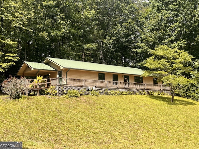 172 Fred Henry Ln, Clayton, GA 30525 - view of front facade featuring a front lawn, a metal roof, and a deck
