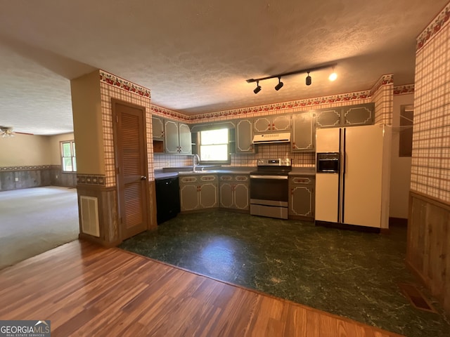 172 Fred Henry Ln, Clayton, GA 30525 - kitchen featuring stainless steel range with electric cooktop, white fridge with ice dispenser, dishwasher, under cabinet range hood, and a textured ceiling