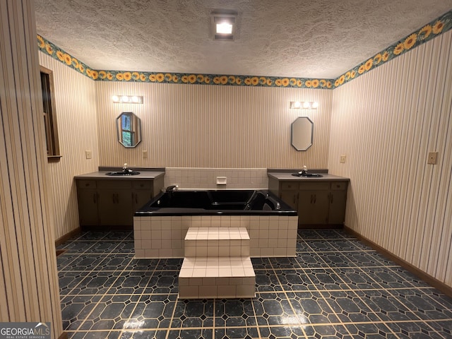 172 Fred Henry Ln, Clayton, GA 30525 - bathroom with wallpapered walls, a garden tub, two vanities, and a textured ceiling