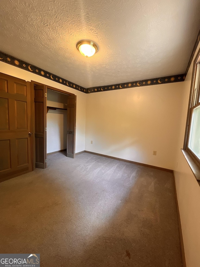 172 Fred Henry Ln, Clayton, GA 30525 - unfurnished bedroom featuring carpet flooring, a closet, and a textured ceiling