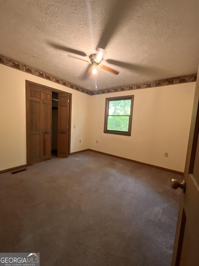 172 Fred Henry Ln, Clayton, GA 30525 - unfurnished bedroom with light colored carpet, a textured ceiling, a closet, and a ceiling fan