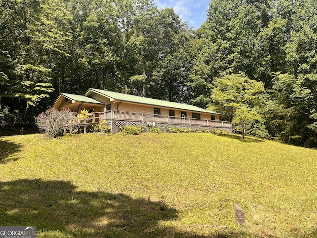 172 Fred Henry Ln, Clayton, GA 30525 - view of front facade with a front lawn, a view of trees, and a deck