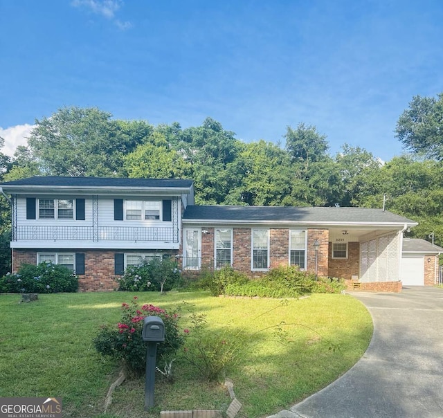 2235 Lyn Ct, Macon, GA 31206 - tri-level home with concrete driveway, a front lawn, and brick siding