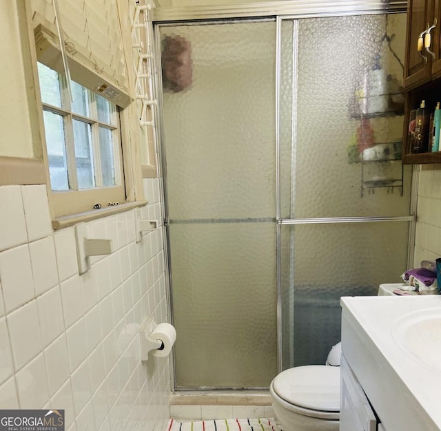 2235 Lyn Ct, Macon, GA 31206 - bathroom featuring tile walls, vanity, and a stall shower