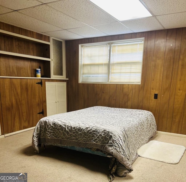 2235 Lyn Ct, Macon, GA 31206 - carpeted bedroom featuring wood walls and a paneled ceiling