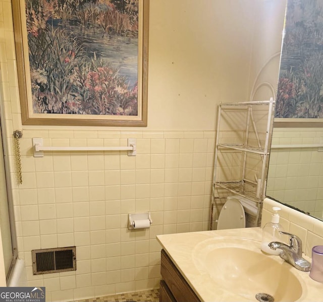 2235 Lyn Ct, Macon, GA 31206 - bathroom featuring tile walls, vanity, and a wainscoted wall