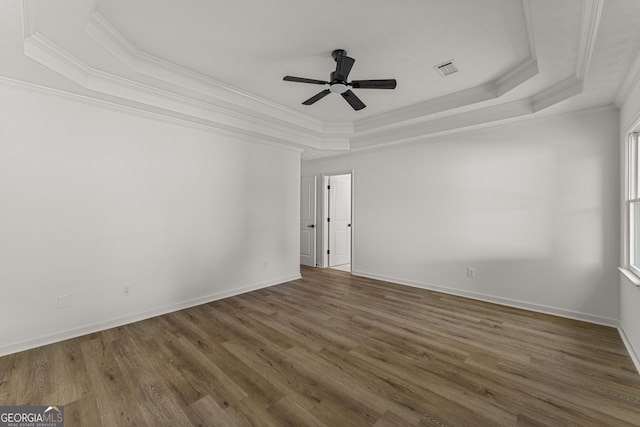5437 Chatham Woods Ct, Columbus, GA 31907 - empty room featuring a tray ceiling, crown molding, wood finished floors, and ceiling fan