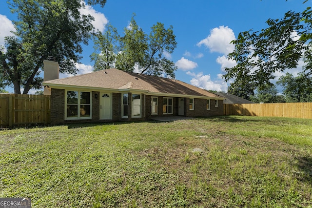 5437 Chatham Woods Ct, Columbus, GA 31907 - back of property featuring a fenced backyard, a chimney, and brick siding
