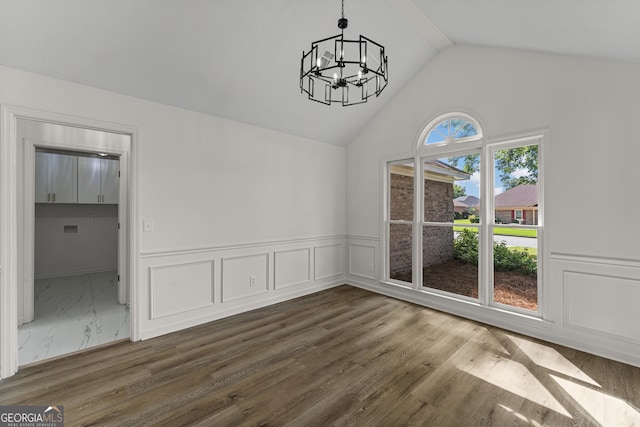5437 Chatham Woods Ct, Columbus, GA 31907 - unfurnished dining area with a chandelier, a wainscoted wall, dark wood finished floors, high vaulted ceiling, and a decorative wall