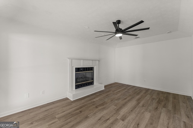 5437 Chatham Woods Ct, Columbus, GA 31907 - unfurnished living room featuring ceiling fan, a tiled fireplace, and wood finished floors