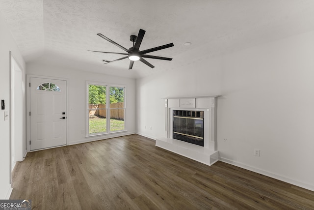 5437 Chatham Woods Ct, Columbus, GA 31907 - unfurnished living room featuring wood finished floors, ceiling fan, a glass covered fireplace, and a textured ceiling