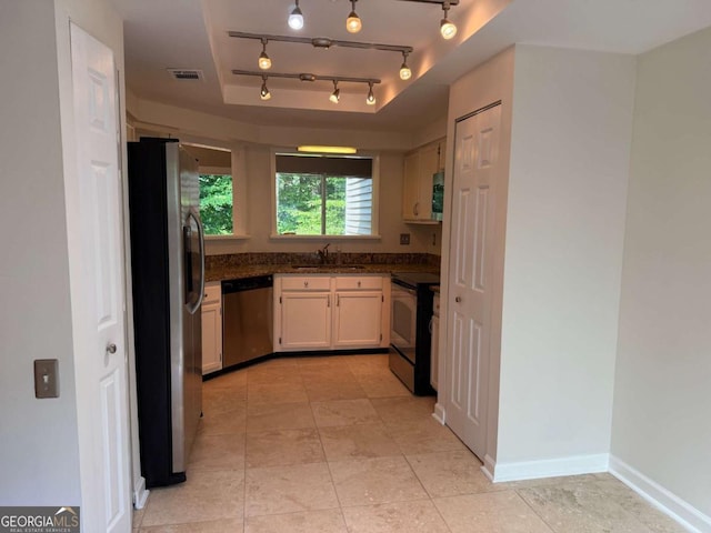 40 Dunwoody Springs Dr, Atlanta, GA 30328 - kitchen featuring stainless steel appliances, a tray ceiling, and light tile patterned floors