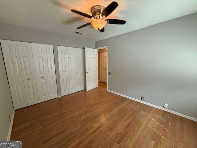 40 Dunwoody Springs Dr, Atlanta, GA 30328 - unfurnished bedroom with multiple closets, wood finished floors, and ceiling fan
