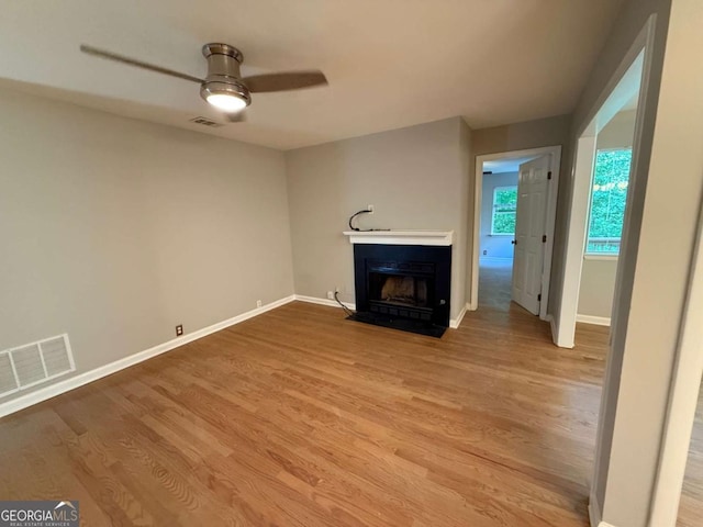 40 Dunwoody Springs Dr, Atlanta, GA 30328 - unfurnished living room featuring ceiling fan, a fireplace with flush hearth, and wood finished floors