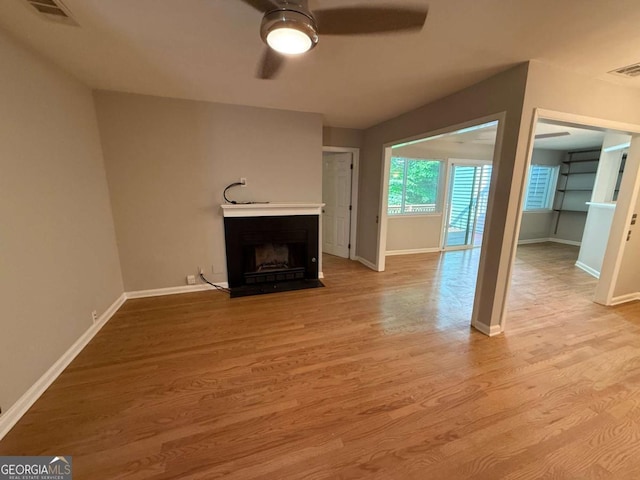 40 Dunwoody Springs Dr, Atlanta, GA 30328 - unfurnished living room featuring ceiling fan, a fireplace with flush hearth, and wood finished floors